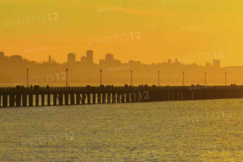 Silhouette of San Francisco city skyline over highway on bay