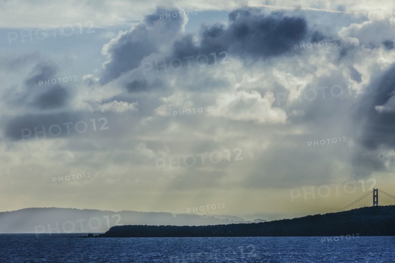 Sunbeams shining through clouds over ocean