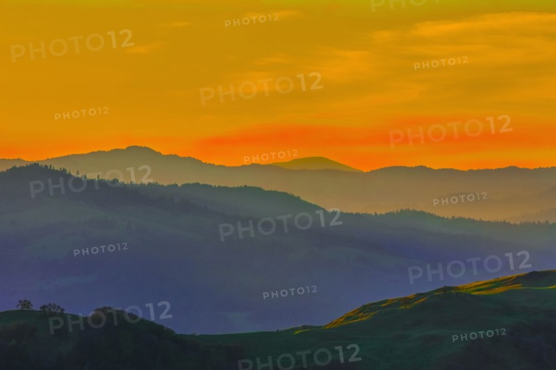 Silhouette of remote hills under sunset sky