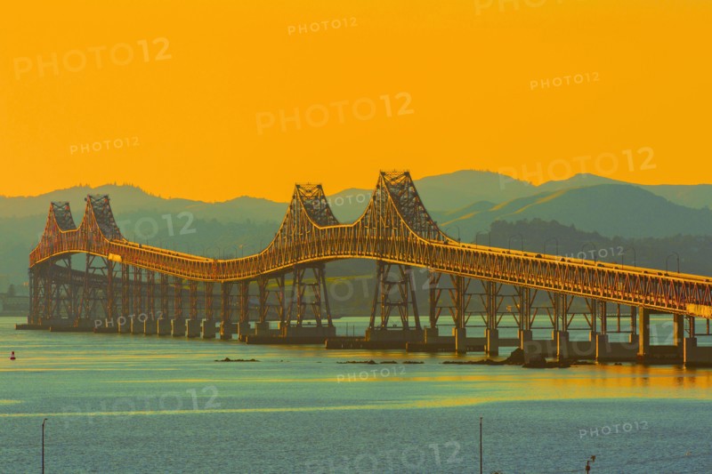 Bridge and river under sunset sky