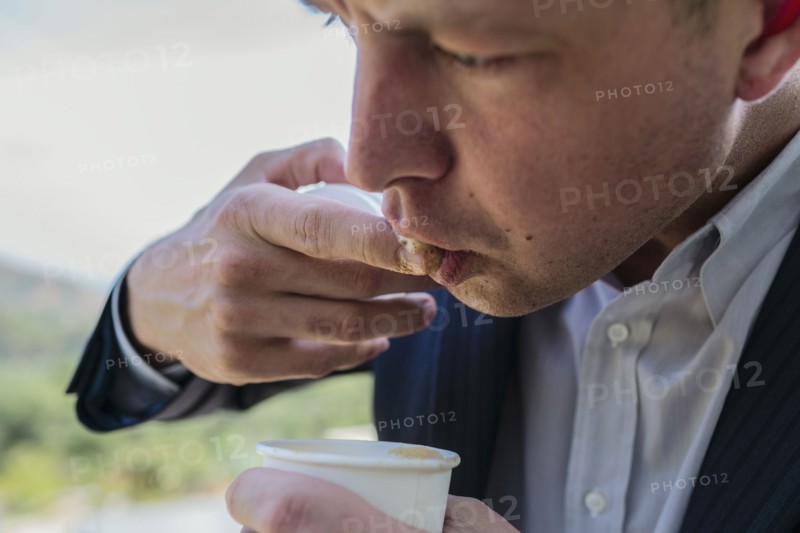 Close up of Caucasian businessman tasting coffee