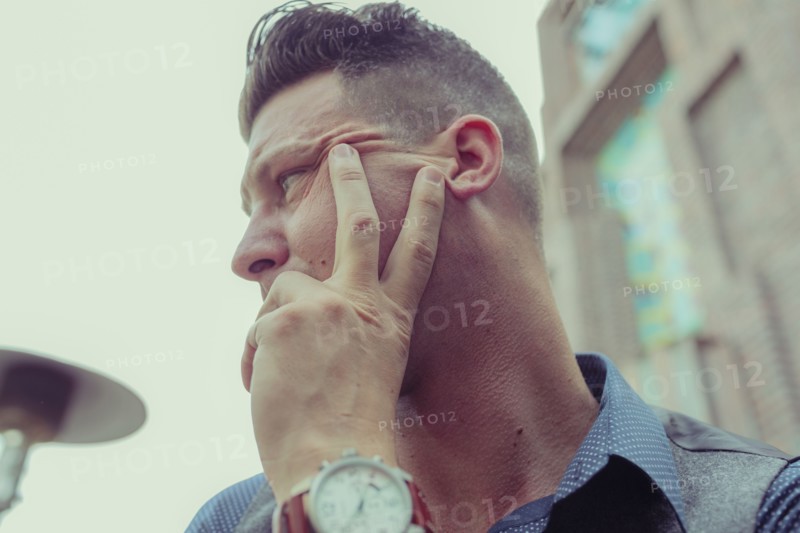 Caucasian businessman resting hand on chin