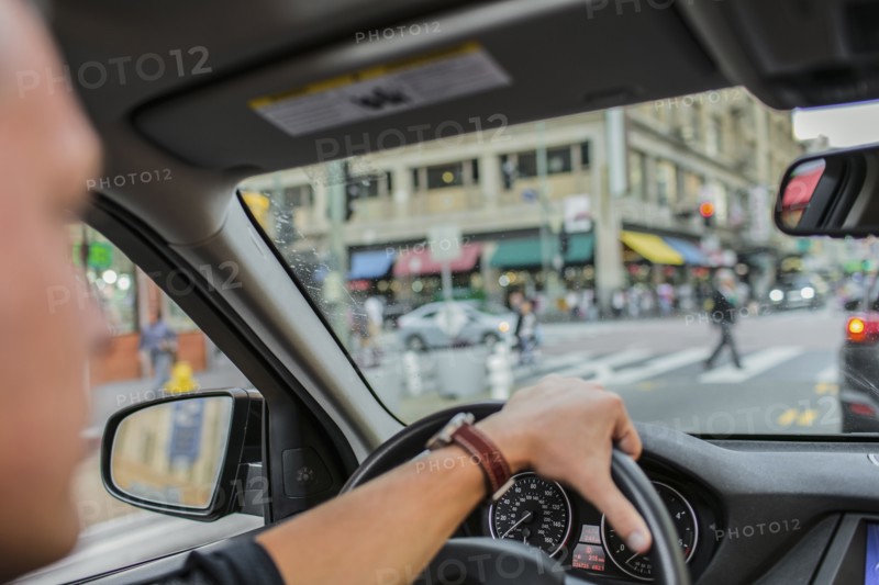Caucasian man driving car in city