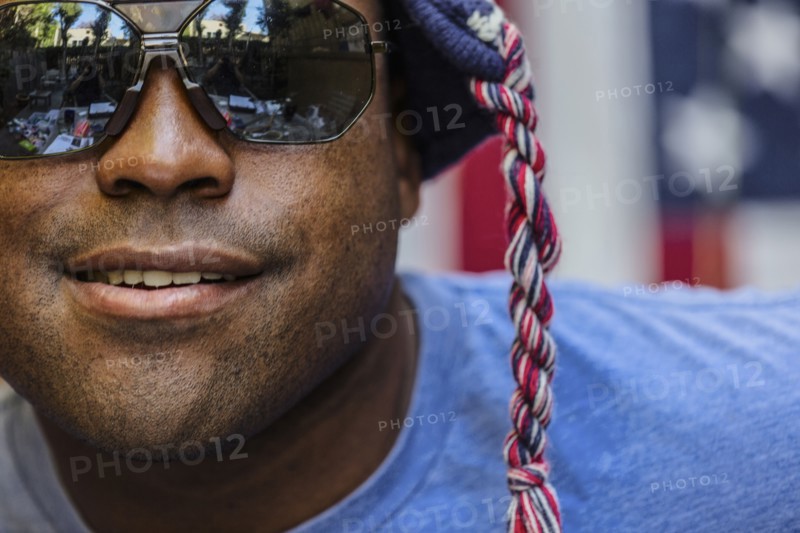Close up of Black man wearing sunglasses and knit cap