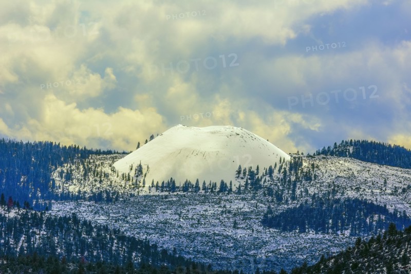 Snowy mountains under clouds