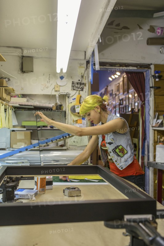 Caucasian artist working in screen print workshop