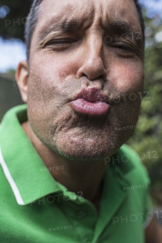 Mixed race man puckering