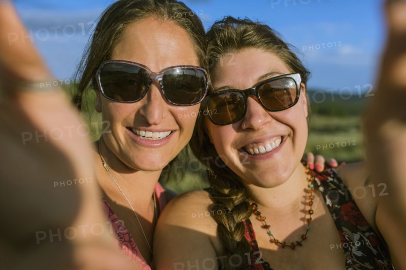 Caucasian women in sunglasses taking selfie