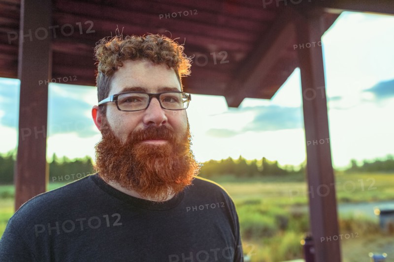 Caucasian man standing on patio in remote field