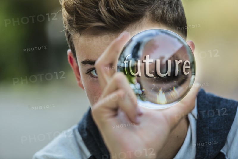 Caucasian teenage boy holding crystal ball