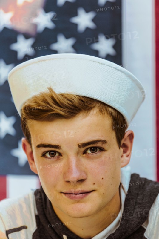 Caucasian teenage boy wearing sailor hat