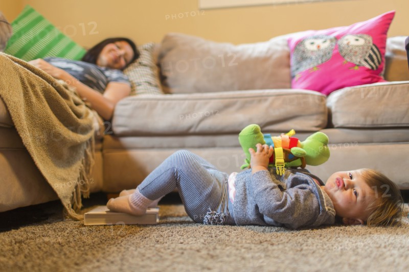 Mother and baby daughter relaxing in living room