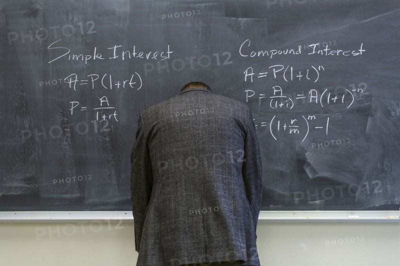 Caucasian teacher frustrated at chalkboard