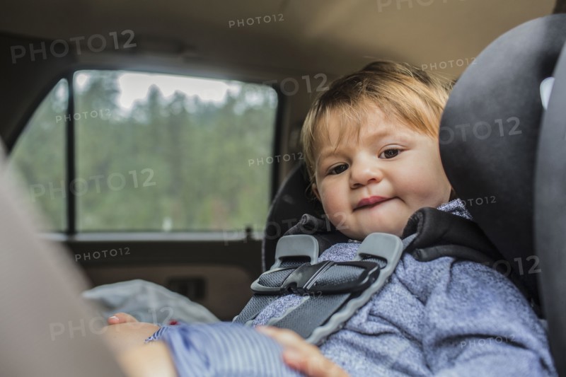 Mixed race girl sitting in car seat