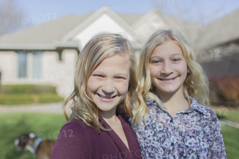 Caucasian girls smiling in yard