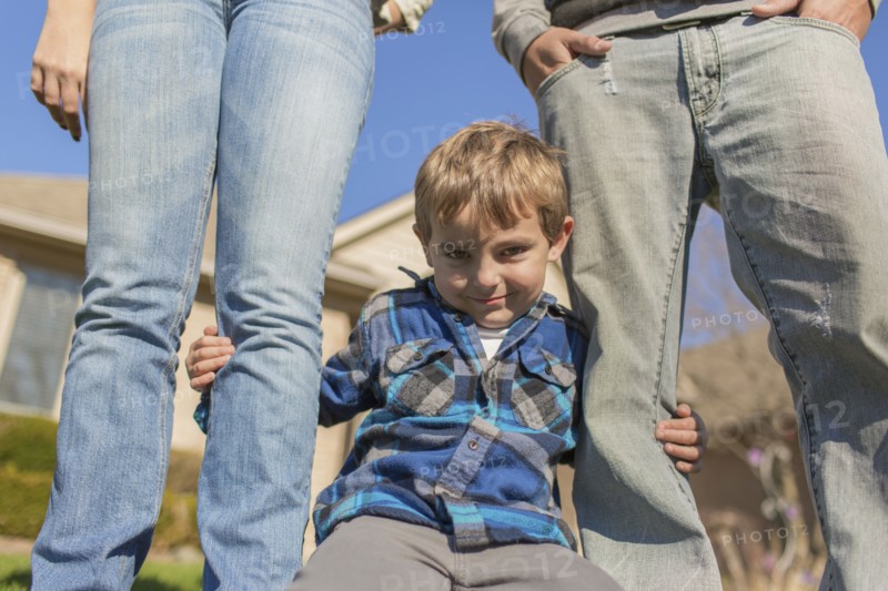 Caucasian parents and son smiling outdoors