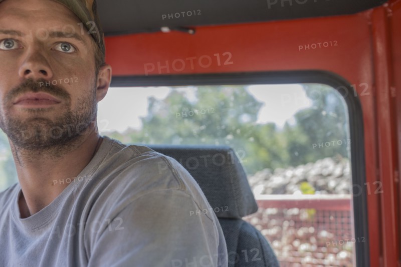 Portrait of serious Caucasian man in tractor