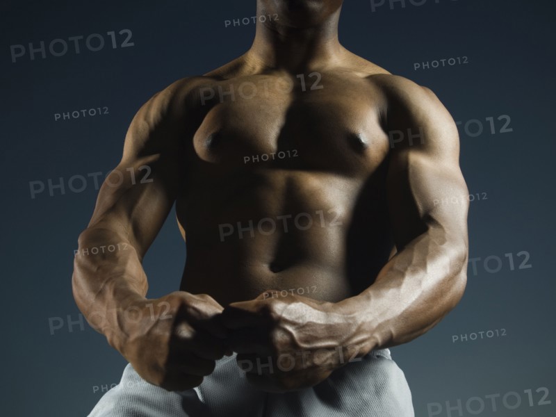African American man flexing muscles