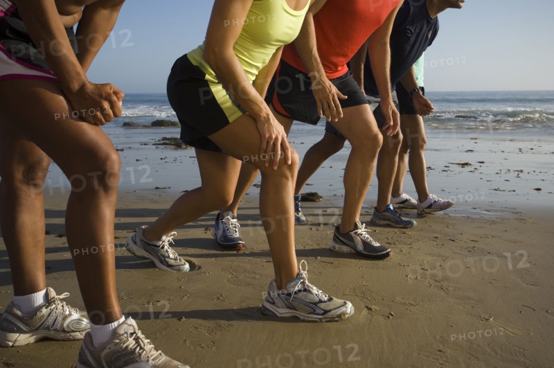 Multi-ethnic runners racing at beach