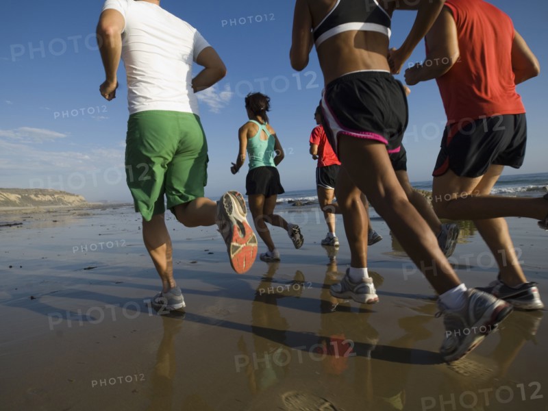 Multi-ethnic runners racing at beach