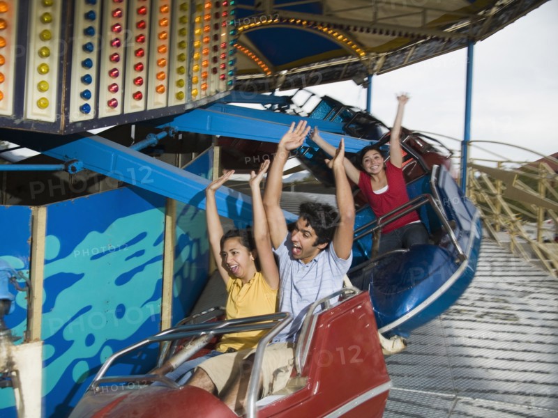 Multi-ethnic teenaged friends on carnival ride