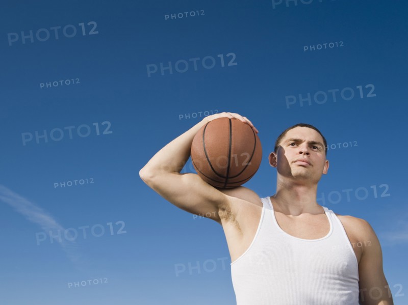 African man holding basketball