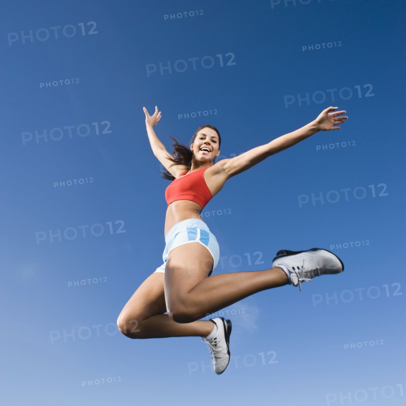 Native American woman jumping in mid-air