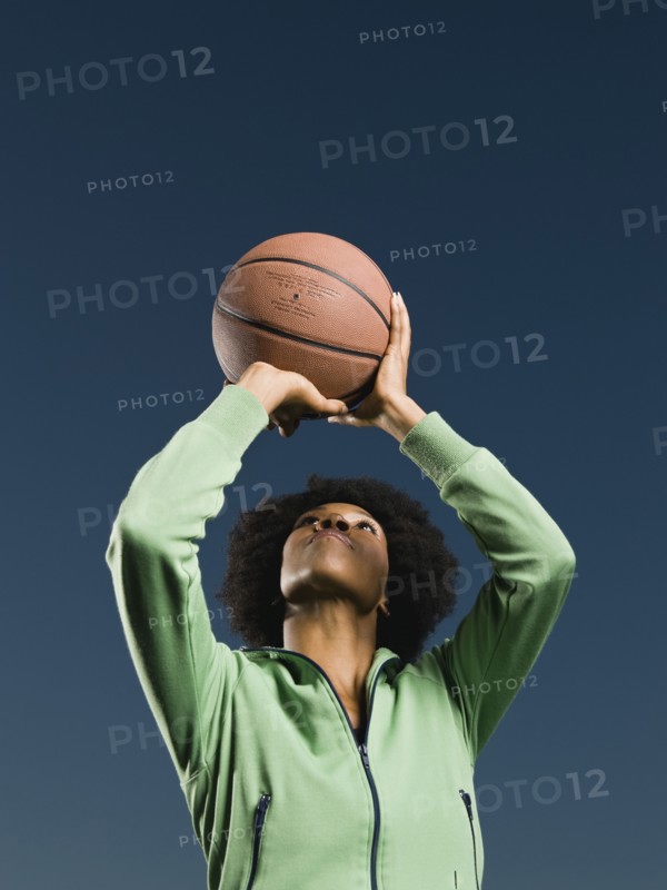 African woman playing basketball