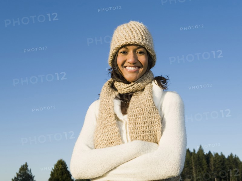 Portrait of mixed race woman smiling with arms crossed