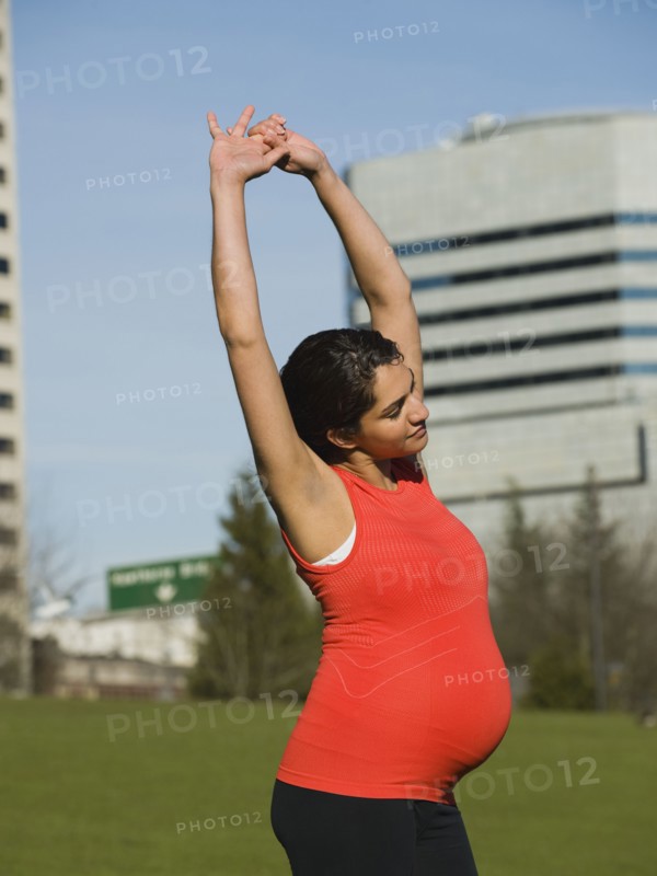 Pregnant Middle Eastern woman stretching