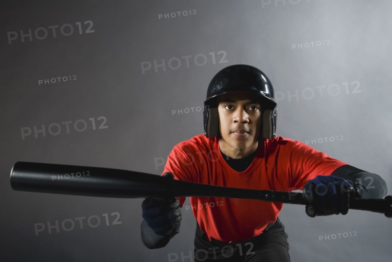 Mixed race baseball player ready to bunt with baseball bat