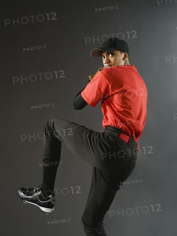 Mixed race baseball pitcher ready to pitch ball