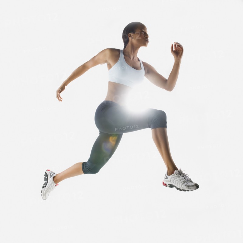 Mixed race woman jumping in mid-air