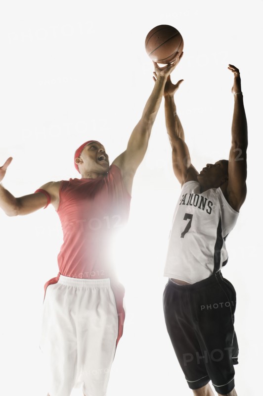 African men jumping for basketball