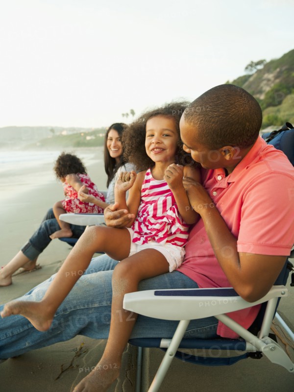 Family sitting together on beach