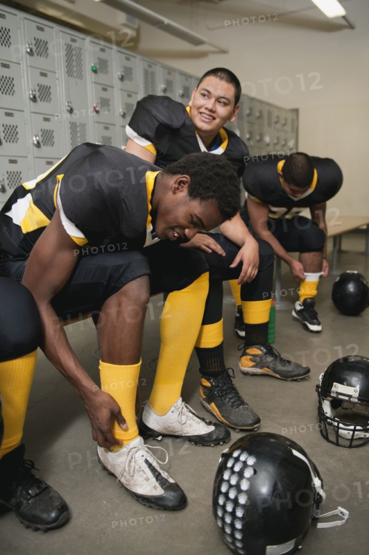 Football players dressing in locker room