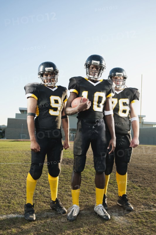 Football players standing on football field