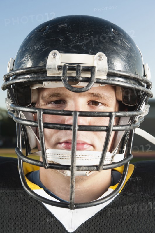 Serious Caucasian football player in helmet
