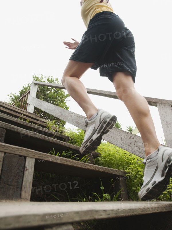Caucasian woman running up stairs for exercise