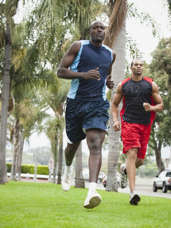 Men running in park together