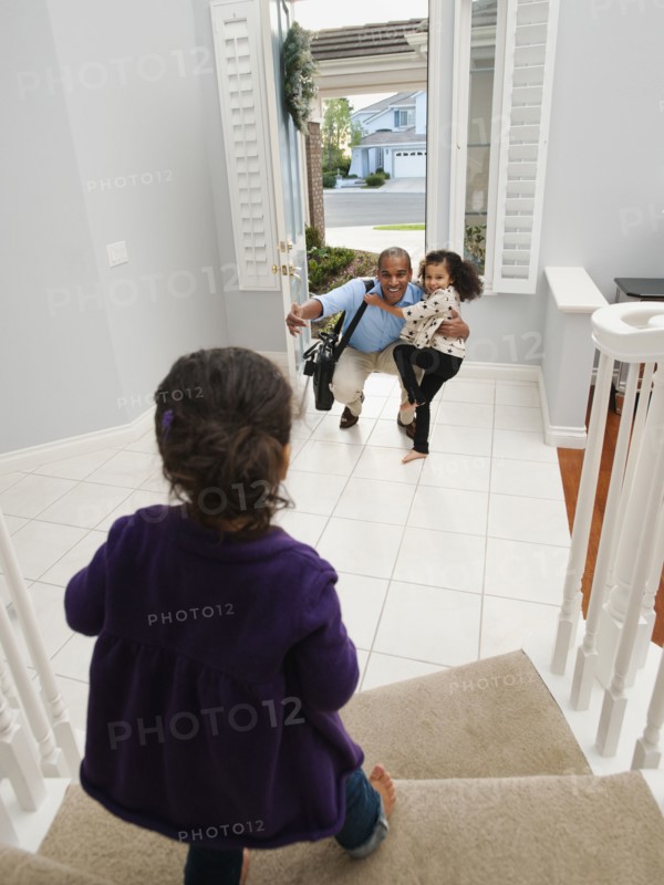 Daughters greeting returning father