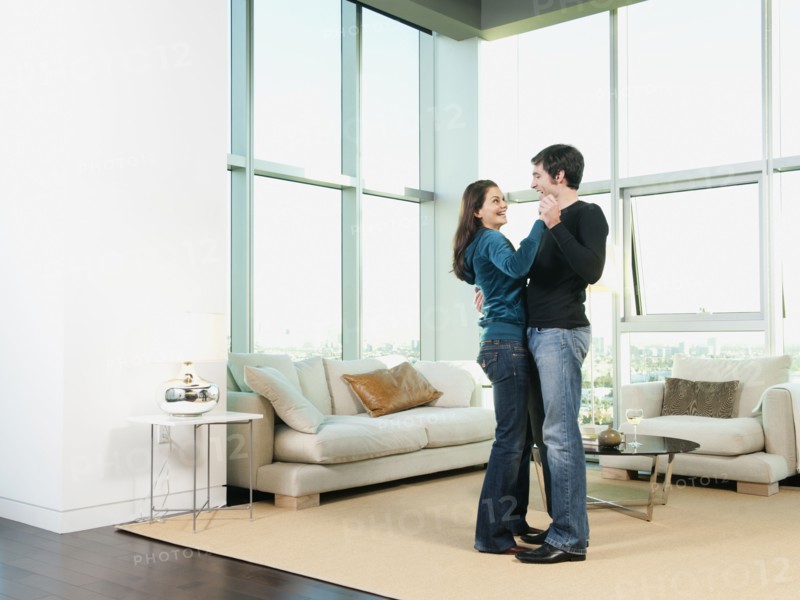 Couple dancing together in living room