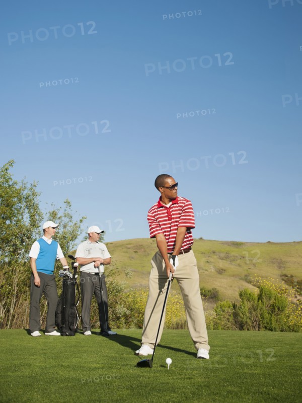 Men playing golf together on golf course