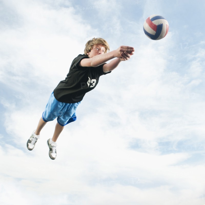 Caucasian teenager returning volleyball