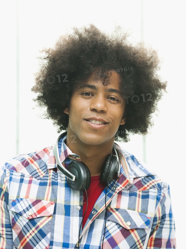 Black man with headphones around neck