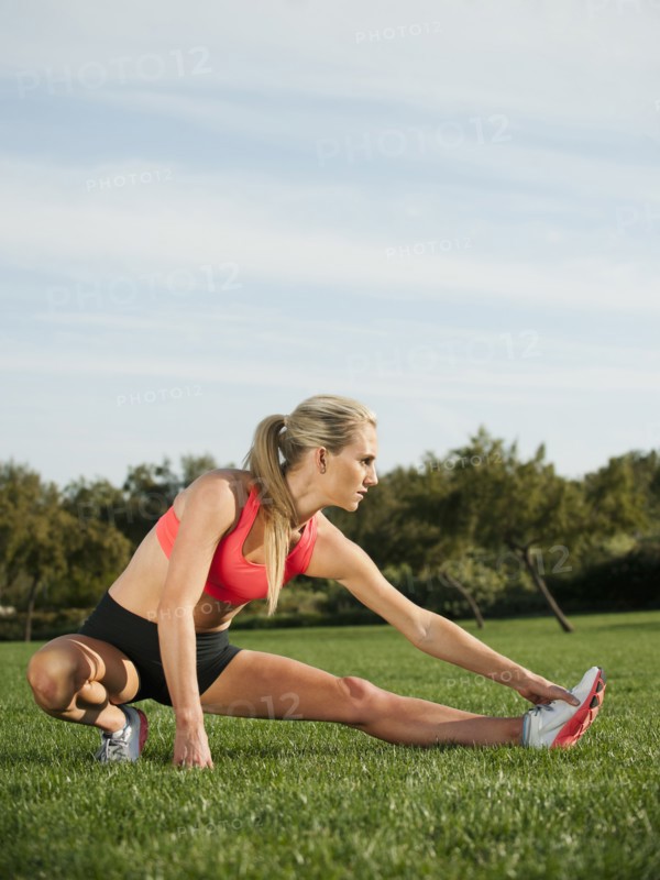 Caucasian woman stretching before exercise