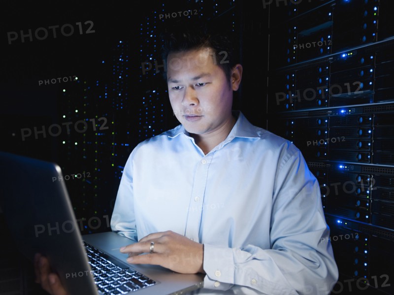 Asian businessman working in server room
