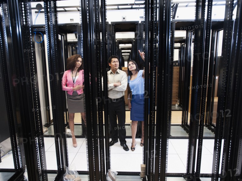 Business people talking in server room