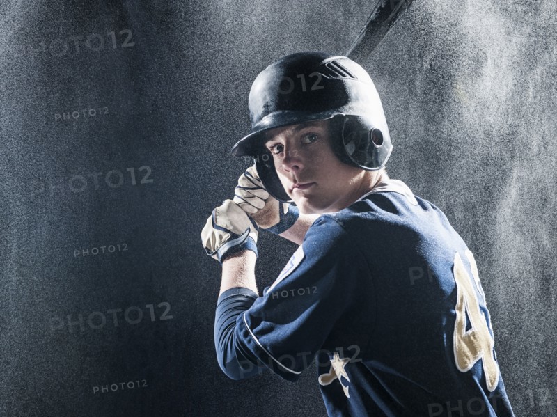 Caucasian baseball player standing in rain