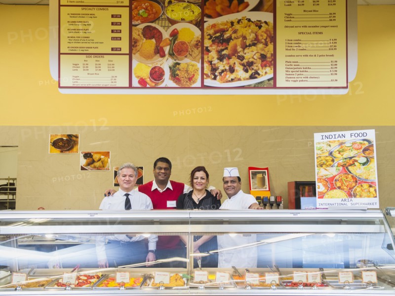 Business people and chefs behind restaurant counter